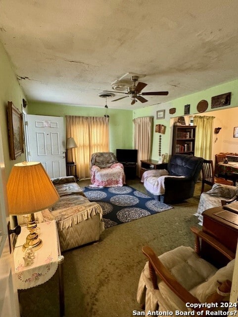 living room featuring carpet flooring and ceiling fan