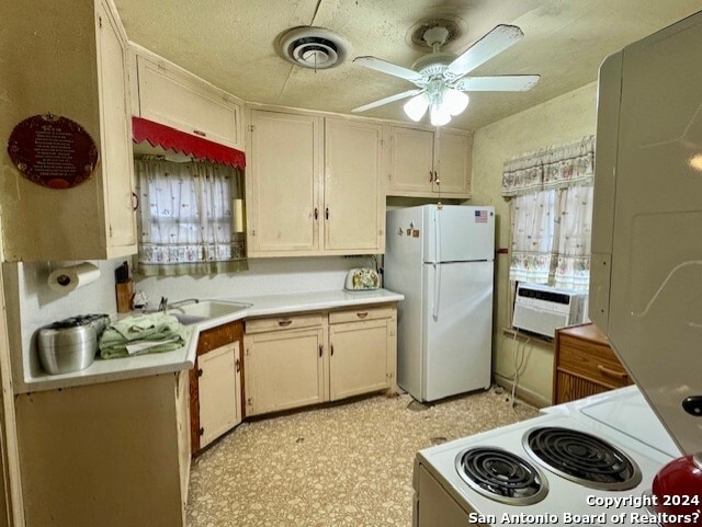 kitchen with range, ceiling fan, white fridge, and sink