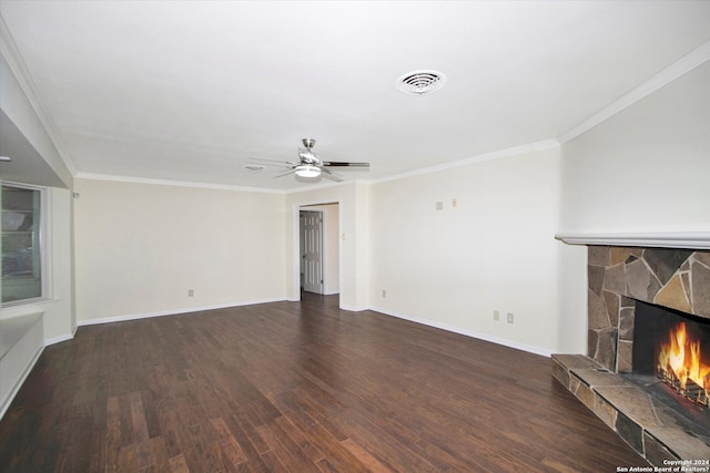 unfurnished living room featuring a stone fireplace, ceiling fan, dark hardwood / wood-style floors, and crown molding