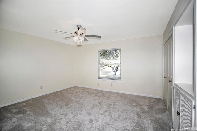 carpeted empty room with ceiling fan