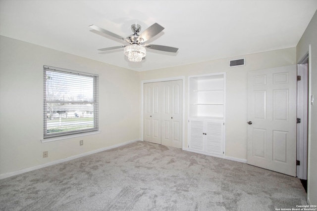 unfurnished bedroom featuring ceiling fan and light colored carpet