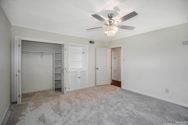 unfurnished bedroom with ceiling fan, a closet, and light colored carpet