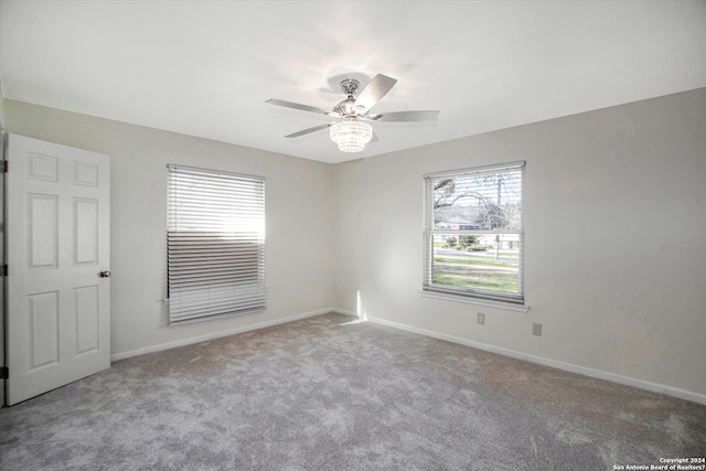 spare room with ceiling fan and light carpet