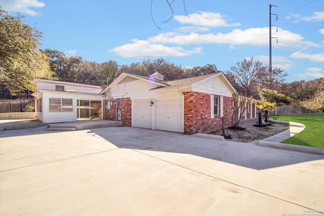 view of front of property with a front lawn and a garage