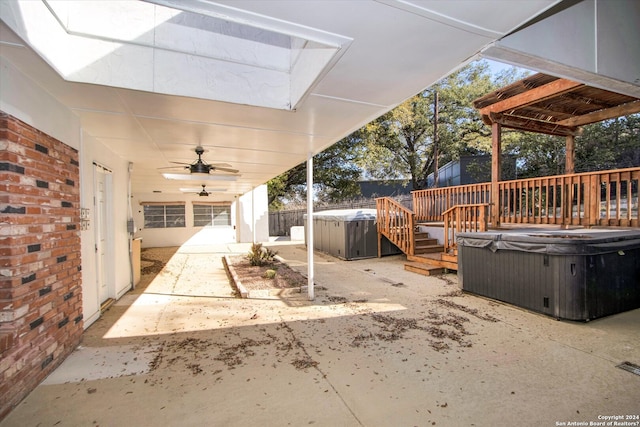 view of patio featuring ceiling fan and a hot tub