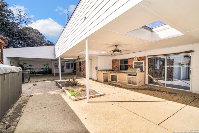 view of patio / terrace with ceiling fan, area for grilling, and a grill