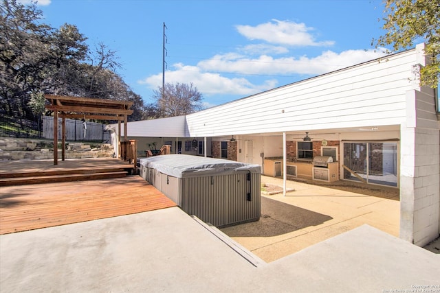 view of patio featuring a deck, a pergola, and a hot tub