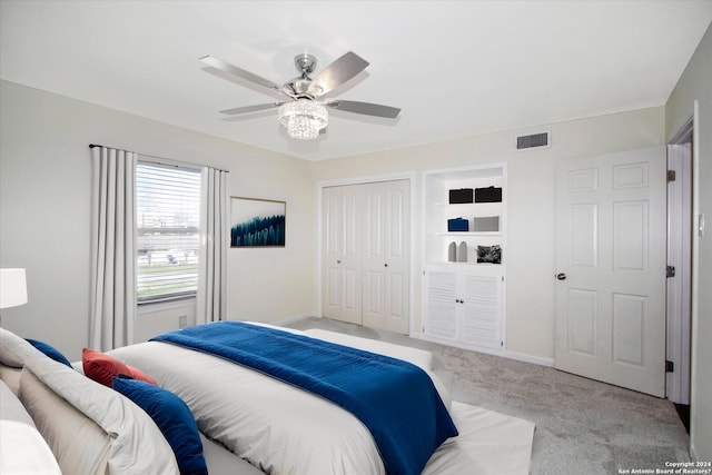 bedroom featuring ceiling fan, light carpet, and a closet