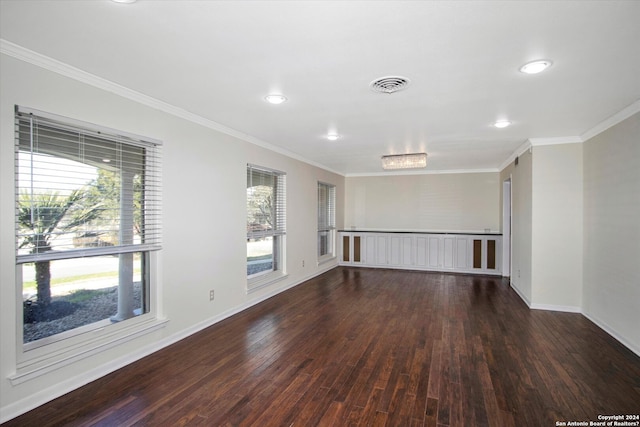 spare room with crown molding and dark hardwood / wood-style floors