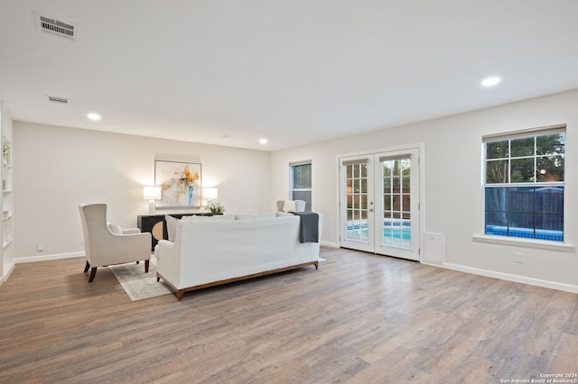 unfurnished living room featuring french doors and hardwood / wood-style flooring