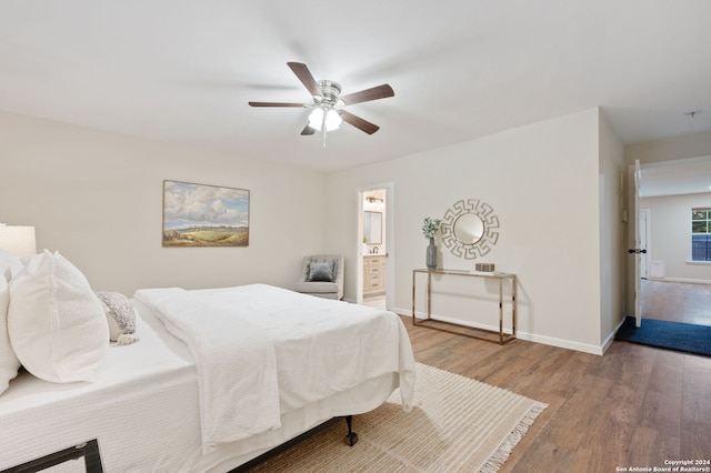 bedroom featuring ceiling fan, hardwood / wood-style floors, and ensuite bathroom