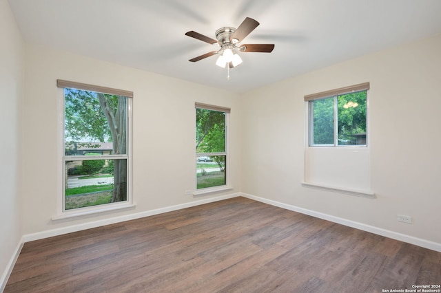 unfurnished room with dark hardwood / wood-style flooring and ceiling fan