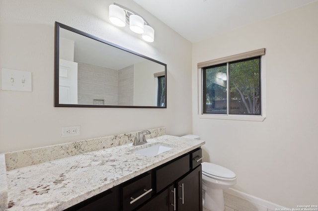 bathroom featuring toilet and vanity