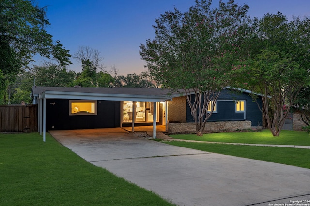 ranch-style house with a yard and a carport