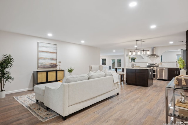 living room with a wealth of natural light and light wood-type flooring