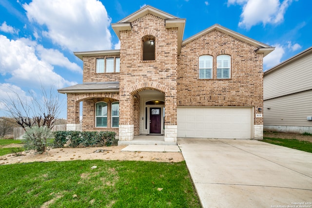 view of front facade featuring a front yard and a garage