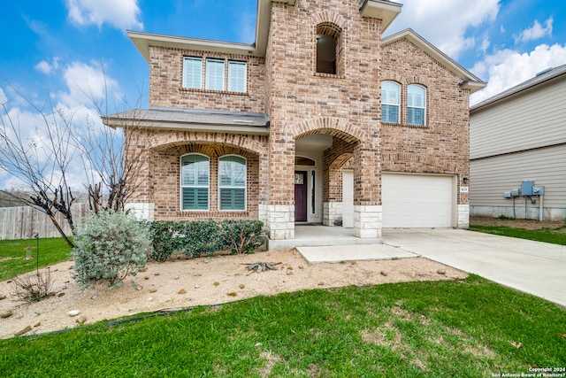 view of front of house featuring a front yard and a garage