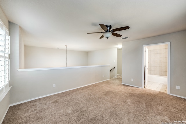 carpeted empty room featuring ceiling fan