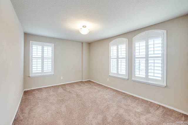 empty room with light colored carpet