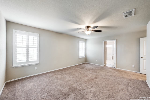 unfurnished room with light carpet, a textured ceiling, and ceiling fan