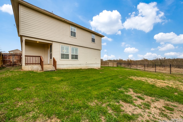 rear view of house with a yard