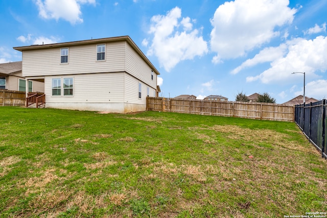 rear view of house with a lawn