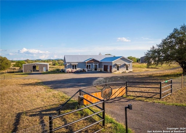 view of front facade with a rural view and an outdoor structure