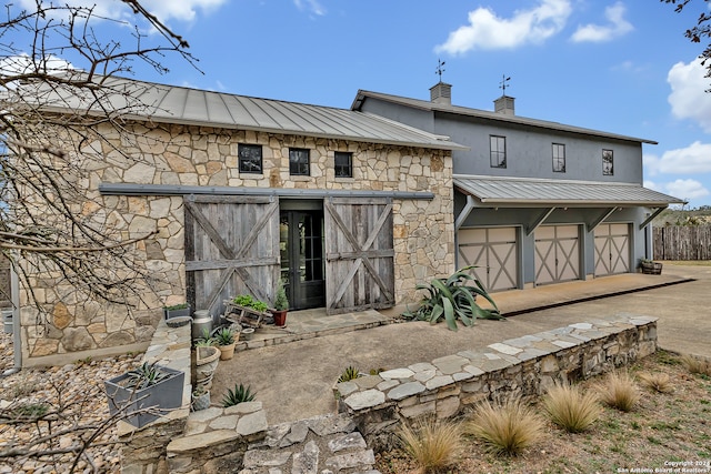 rear view of house featuring a garage