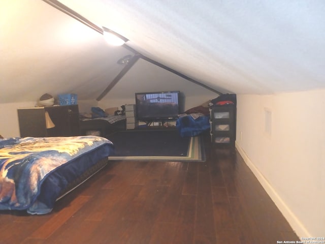 bedroom with lofted ceiling and dark wood-type flooring