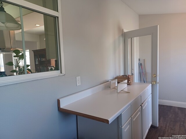 bathroom with vanity, vaulted ceiling, and hardwood / wood-style flooring