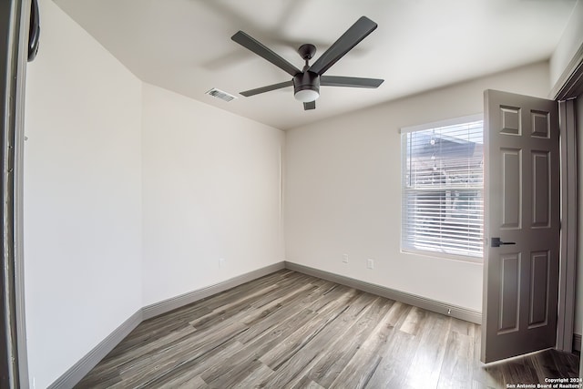 spare room featuring ceiling fan and light wood-type flooring