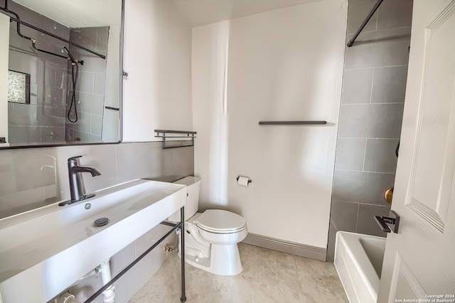 full bathroom with toilet, tile flooring, tiled shower / bath combo, and vanity