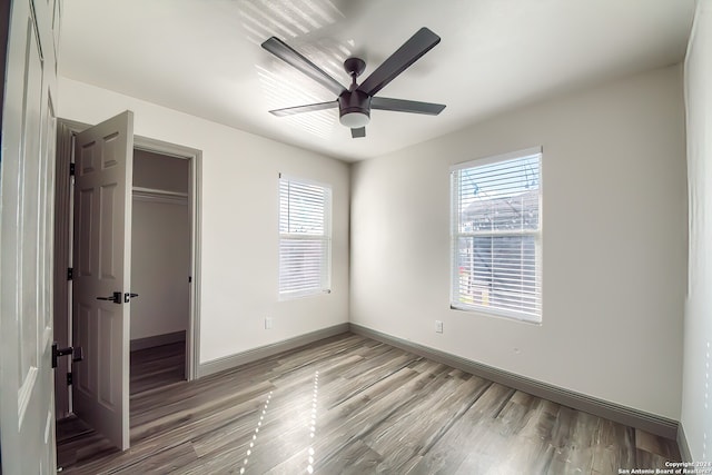 unfurnished bedroom featuring ceiling fan, a closet, and light hardwood / wood-style flooring