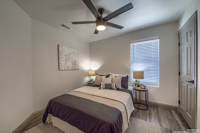 bedroom with ceiling fan and hardwood / wood-style flooring