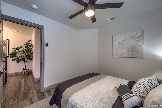 bedroom featuring ceiling fan and dark wood-type flooring