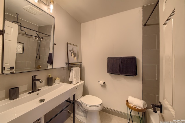 bathroom with toilet, tile floors, and vanity