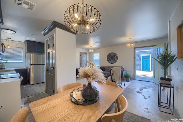 dining area with an inviting chandelier