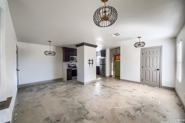 interior space featuring dark brown cabinetry, stainless steel appliances, and decorative light fixtures