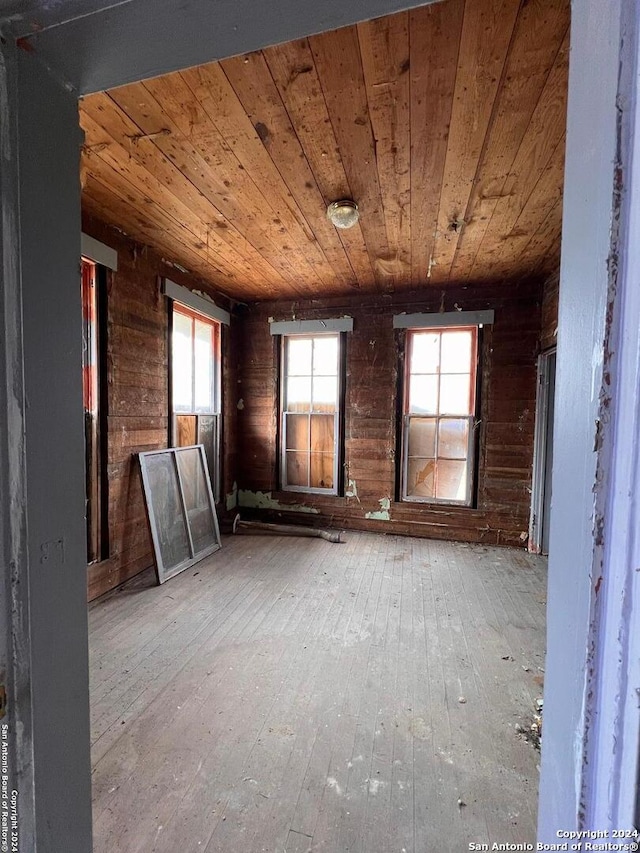 misc room featuring wooden ceiling, wood-type flooring, and a wealth of natural light