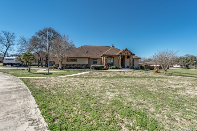 ranch-style home with a front lawn