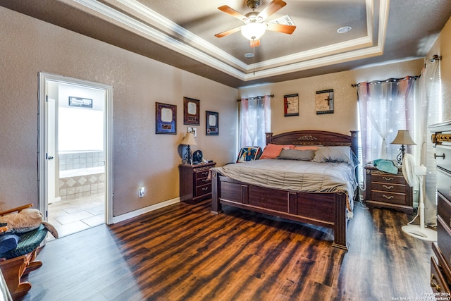 bedroom featuring ceiling fan, multiple windows, dark wood-type flooring, and a raised ceiling