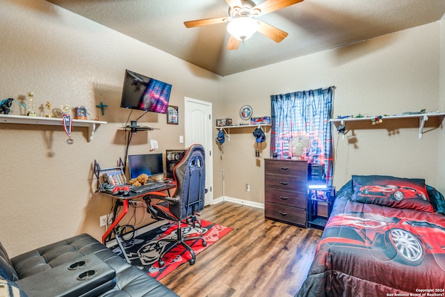 bedroom with dark hardwood / wood-style flooring and ceiling fan