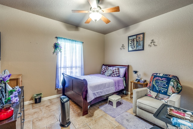 bedroom with ceiling fan, a textured ceiling, and light tile floors