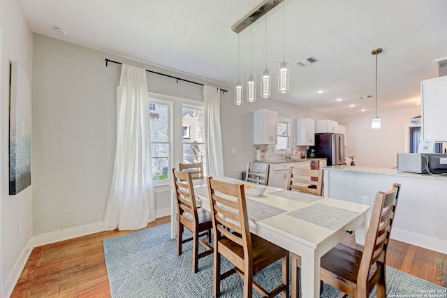 dining room featuring light hardwood / wood-style floors and sink