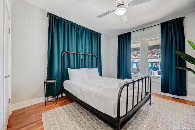 bedroom with ceiling fan and light hardwood / wood-style flooring