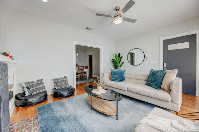 living room featuring ceiling fan and light wood-type flooring