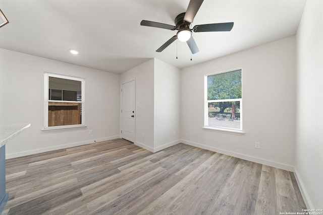 spare room with light hardwood / wood-style flooring and ceiling fan