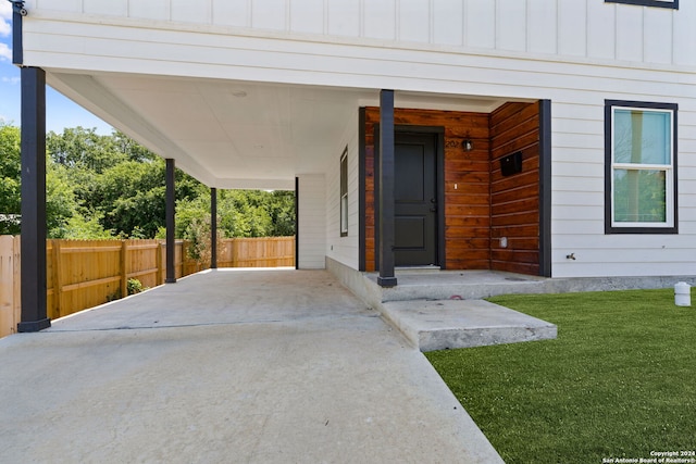 doorway to property with a yard