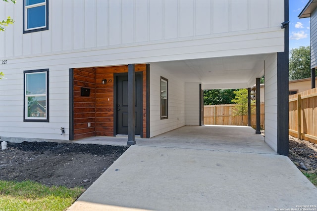 view of exterior entry featuring a carport