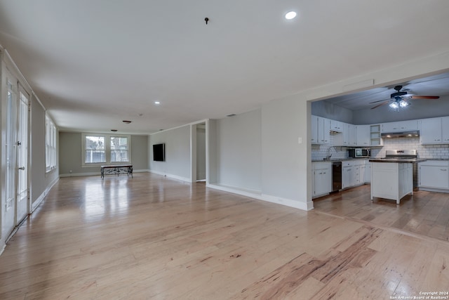 unfurnished living room with light hardwood / wood-style flooring, sink, and ceiling fan